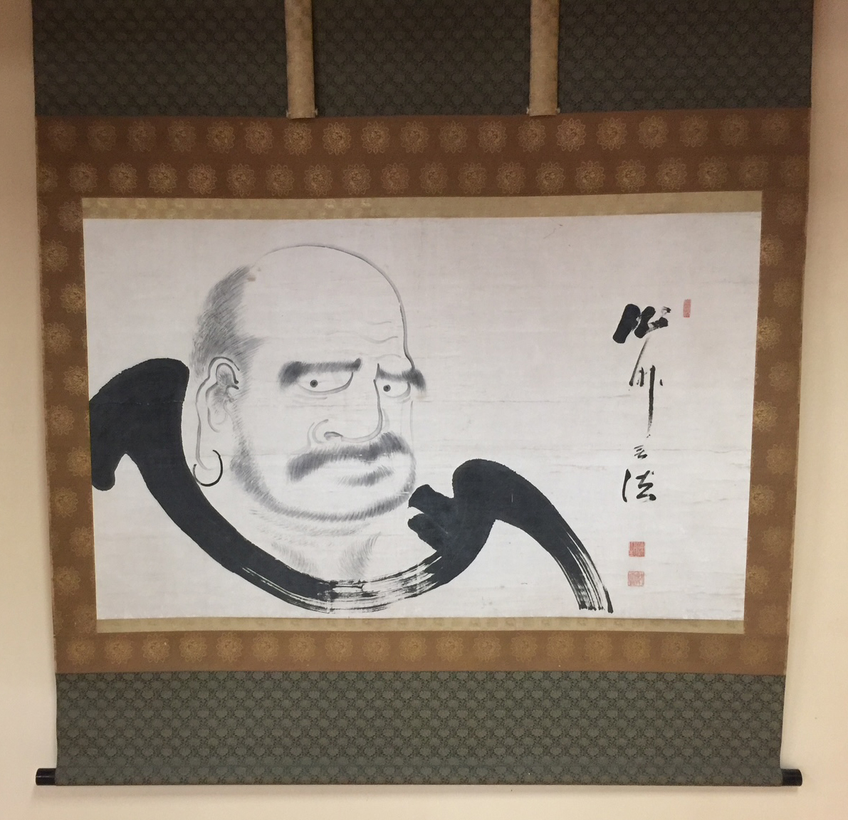 Traditional Chinese calligraphy of the character 智 (Zhi), meaning wisdom and knowledge. Bold brushwork on textured paper with red seal stamp.